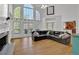 Bright living room featuring a fireplace, large windows, and wood floors at 241 Rose Ridge Dr, Canton, GA 30115
