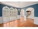 Elegant living room featuring hardwood floors, arched windows, and classic trim details at 241 Rose Ridge Dr, Canton, GA 30115