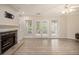 Living room featuring a fireplace, wood flooring, and plenty of natural light at 241 Rose Ridge Dr, Canton, GA 30115