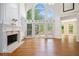 Bright, open living room with a fireplace, hardwood floors, and a wall of windows at 241 Rose Ridge Dr, Canton, GA 30115