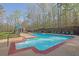 Outdoor pool area with pool house, surrounded by mature trees, lounge seating and lush landscape at 241 Rose Ridge Dr, Canton, GA 30115