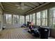 Comfortable screened porch with wood flooring and views of the wooded yard at 241 Rose Ridge Dr, Canton, GA 30115