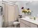 Stylish bathroom with a vanity, sink, mirror, flowers and a shower with a striped curtain at 400 Paulownia Cir, Mcdonough, GA 30253