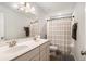 Bathroom features a double sink vanity, large mirror, and a shower with a curtain at 400 Paulownia Cir, Mcdonough, GA 30253