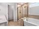 Elegant bathroom featuring a soaking tub, a separate glass-enclosed shower, and a double vanity at 400 Paulownia Cir, Mcdonough, GA 30253