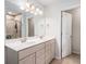 Modern bathroom with a double vanity, a large mirror, and a glass-enclosed shower at 400 Paulownia Cir, Mcdonough, GA 30253