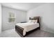 Cozy bedroom features a comfortable bed, soft carpet, and natural light from the window at 400 Paulownia Cir, Mcdonough, GA 30253