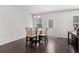 Bright dining area with hardwood floors, modern chandelier, and dining table with four chairs at 400 Paulownia Cir, Mcdonough, GA 30253