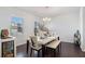 Elegant dining room featuring hardwood floors, ample natural light, and modern table with bench seating at 400 Paulownia Cir, Mcdonough, GA 30253