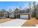This stunning two-story home features a well-maintained lawn and a spacious driveway leading to an attached garage at 400 Paulownia Cir, Mcdonough, GA 30253