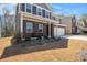 Two story home with beautiful lawn and front patio featuring outdoor chairs and meticulous landscaping at 400 Paulownia Cir, Mcdonough, GA 30253