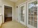 Charming balcony offers natural light from windows, with an open entry to the living room at 8020 Woodland Ln, Alpharetta, GA 30009