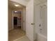 Well-lit bathroom features a shower and tub combination and white tiled walls at 8020 Woodland Ln, Alpharetta, GA 30009