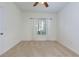 Bright bedroom with neutral carpet, ceiling fan, and natural lighting at 8020 Woodland Ln, Alpharetta, GA 30009