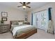 Comfortable bedroom with balcony access and decorative wall art at 8020 Woodland Ln, Alpharetta, GA 30009