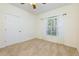 Bright bedroom with a ceiling fan, carpet floors, and a window with natural light at 8020 Woodland Ln, Alpharetta, GA 30009