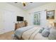 Cozy bedroom with natural light, a dresser, and a beautifully framed landscape painting at 8020 Woodland Ln, Alpharetta, GA 30009