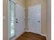 Clean entryway featuring white doors, fresh paint, and hardwood floors at 8020 Woodland Ln, Alpharetta, GA 30009