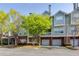 Charming multi-story townhouse with brick accents and manicured landscaping at 8020 Woodland Ln, Alpharetta, GA 30009