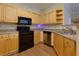 Kitchen features stainless steel appliances, wood cabinets, and laminate flooring at 8020 Woodland Ln, Alpharetta, GA 30009