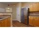 Kitchen featuring light wood cabinets and stainless steel refrigerator at 8020 Woodland Ln, Alpharetta, GA 30009