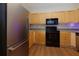 Kitchen features stainless steel appliances, wood cabinets, and laminate flooring at 8020 Woodland Ln, Alpharetta, GA 30009