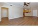 Open-concept living space with wood floors, view of the kitchen and plenty of space at 8020 Woodland Ln, Alpharetta, GA 30009