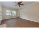 Bright living room featuring hardwood floors, a fireplace, and natural light at 8020 Woodland Ln, Alpharetta, GA 30009