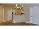 Open-concept living space featuring a breakfast bar and dining area with stylish chandelier lighting at 8020 Woodland Ln, Alpharetta, GA 30009