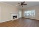 Bright living room with a fireplace, hardwood floors, and access to the outdoor balcony at 8020 Woodland Ln, Alpharetta, GA 30009
