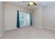Large main bedroom with ceiling fan, carpet, and bright sliding glass door to balcony at 8020 Woodland Ln, Alpharetta, GA 30009