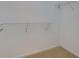 Walk-in closet with carpet and white shelving for storage at 8020 Woodland Ln, Alpharetta, GA 30009