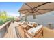 Beautiful outdoor deck with seating, a large umbrella, and a lush green landscape at 1438 Kings Park Nw Dr, Kennesaw, GA 30152