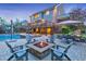 Luxurious backyard featuring a multi-level deck, outdoor seating, fire pit, and a sparkling swimming pool at 1438 Kings Park Nw Dr, Kennesaw, GA 30152