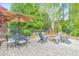 Enjoy outdoor living with a patio set, fire pit, and mature landscaping in the backyard at 1438 Kings Park Nw Dr, Kennesaw, GA 30152