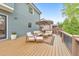 Relaxing outdoor deck with lounge furniture, an umbrella, and a manicured lawn at 1438 Kings Park Nw Dr, Kennesaw, GA 30152