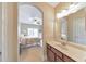 Bathroom featuring a vanity and mirror, with a view into an adjacent bedroom at 1438 Kings Park Nw Dr, Kennesaw, GA 30152