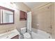 Bathroom with a toilet, vanity and mirror, with an integrated shower/tub with tile surround at 1438 Kings Park Nw Dr, Kennesaw, GA 30152