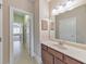 Bathroom with a vanity and mirror, leading to a bedroom in the distance at 1438 Kings Park Nw Dr, Kennesaw, GA 30152