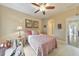 Bedroom with a bed, desk and a chair, complemented by artwork and natural light at 1438 Kings Park Nw Dr, Kennesaw, GA 30152