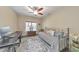 Cozy bedroom with a daybed, ceiling fan, neutral paint, and a decorative area rug at 1438 Kings Park Nw Dr, Kennesaw, GA 30152