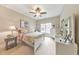 Cozy bedroom featuring a ceiling fan, neutral walls, and a comfortable bed with floral bedding at 1438 Kings Park Nw Dr, Kennesaw, GA 30152