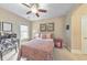 Well-lit bedroom featuring a bed, desk and a chair, complemented by artwork and natural light at 1438 Kings Park Nw Dr, Kennesaw, GA 30152