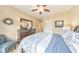 Bedroom featuring a bed, dresser, mirror, decor and chair with a patterned blue and white bed spread at 1438 Kings Park Nw Dr, Kennesaw, GA 30152