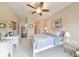 Bright bedroom with a ceiling fan, neutral walls, and a comfy bed with floral bedding at 1438 Kings Park Nw Dr, Kennesaw, GA 30152