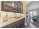 Butler pantry with sleek countertops, cabinetry, and easy access to dining area at 1438 Kings Park Nw Dr, Kennesaw, GA 30152