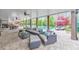 Comfortable covered patio with a ceiling fan and outdoor furniture overlooks the beautiful pool area at 1438 Kings Park Nw Dr, Kennesaw, GA 30152