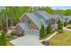 Stunning brick home features a three-car garage, manicured landscaping, and beautiful architectural details at 1438 Kings Park Nw Dr, Kennesaw, GA 30152