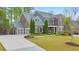 Beautiful brick home with a manicured lawn, charming front porch, and elegant landscaping at 1438 Kings Park Nw Dr, Kennesaw, GA 30152
