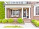 Charming brick home with a welcoming front porch, cozy seating, and manicured landscaping at 1438 Kings Park Nw Dr, Kennesaw, GA 30152